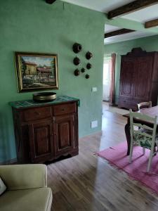 a living room with a couch and a table at Casa relax immersa nel verde della natura in Casalborgone