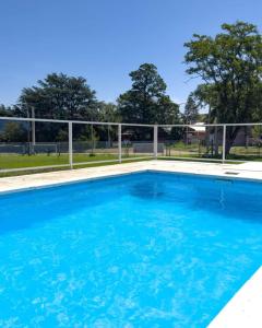 a swimming pool with blue water at Hermoso Triplex en Sierra de la Ventana in Sierra de la Ventana