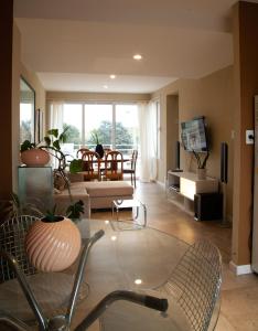 a living room with a couch and a table at Hermoso Triplex en Sierra de la Ventana in Sierra de la Ventana