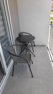 a table and a chair on a balcony at Apartman Stamenković in Veliko Gradište