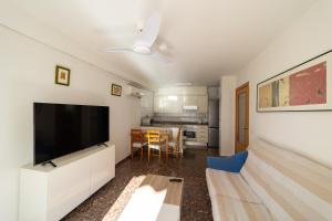 a living room with a large flat screen tv at (Playa Voramar) Apartamento hasta 6 personas in Benicàssim