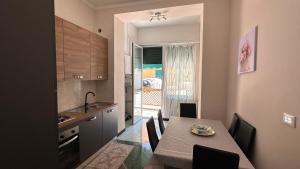 a kitchen and dining room with a table and chairs at Edens house con parcheggio privato in Rapallo
