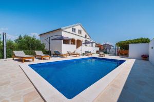 a swimming pool in front of a house at Villa Gabi in Pridraga +37 photos