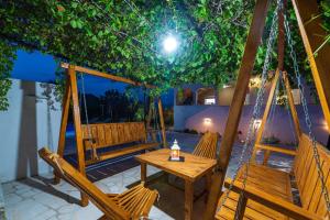 a patio with chairs and a table and a swing at Villa Gabi in Pridraga
