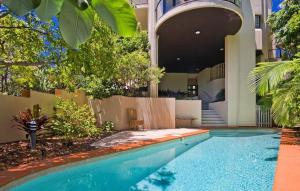 a swimming pool in front of a building at Da Vinci, Apartment 1, Sunshine Beach in Noosa Heads