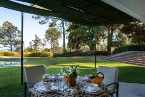 a table under a tent with a table and chairs at House with pool and elegant garden in Estoril in Estoril