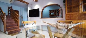 a room with two chairs and a hammock in it at Arenita in Puerto