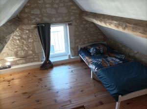 a bedroom with a bed and a window at L'instant Civray in Civray-sur-Esves