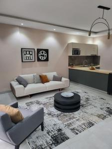a living room with two couches and a kitchen at Dakar Dreams Spinelle in Dakar