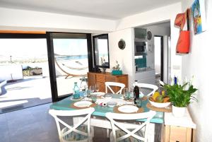 a kitchen and dining room with a table and chairs at La Belle Vie in Famara +38 photos