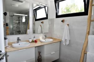 a bathroom with two sinks and a mirror at La Belle Vie in Famara