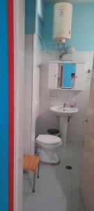 a white bathroom with a toilet and a sink at Faros in Platamonas