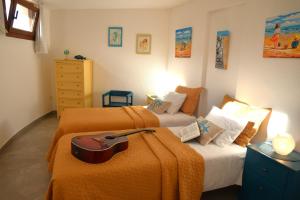 a bedroom with two beds with orange sheets at La Belle Vie in Famara
