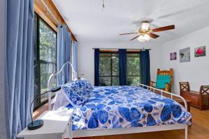 a bedroom with a bed and a ceiling fan at Miss Lilian's House in Wimberley