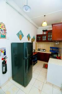a kitchen with a black refrigerator in a room at Luxury My Villa Bentota 200m Bentota Beach in Bentota