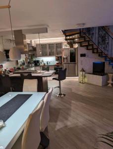 a kitchen and living room with a staircase in it at Das Haus am Kanal. in Lübeck