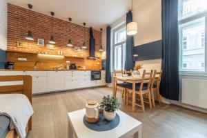a kitchen and living room with a table and chairs at A Prague Apartments - Lesser Town in Prague