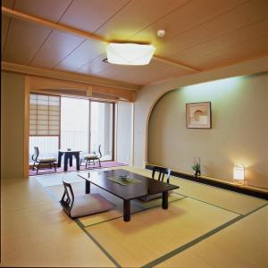 a living room with a table and a dining room at Hakusen in Yonago