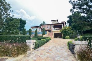 an exterior view of a house with a driveway at Private Pool Villa & Golf - Toscana House Khaoyai 4 Bedrooms 10 Guests in Ban Rai Khlong Sai