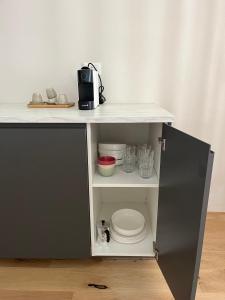 a shelf with a toilet and a microwave on it at TEODORA SUITE blue in Ravenna