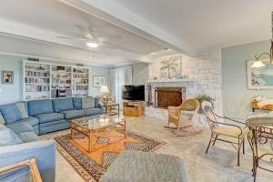 a living room with a blue couch and a fireplace at Dog Friendly Beach House in Fernandina Beach