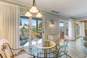a dining room with a glass table and chairs at Dog Friendly Beach House in Fernandina Beach