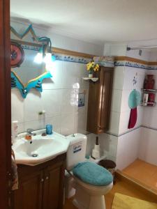 a bathroom with a toilet and a sink at vintage apartment with port view in Chios