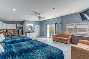 a bedroom with two beds and a living room at Boardwalk Sand & Surf Beach Hotel Oceanfront in Seaside Heights