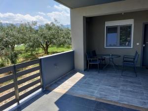 a balcony of a house with a table and chairs at MAKexclusive in Leptokarya