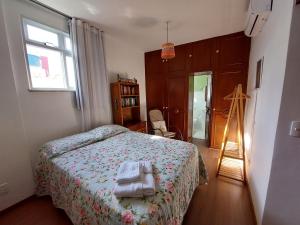 a bedroom with a bed with a towel on it at Espaço, Conforto e vista para o Cristo no Rio. in Rio de Janeiro