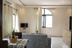 a living room with a couch and a table at Résidence des Amazones Appartement 2 in Cotonou