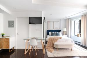 a white bedroom with a bed and a desk at 809-2B New bldg Jr columbus circle Balcony WD in New York