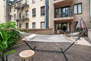 a hammock on a patio in front of a building at 809-2B New bldg Jr columbus circle Balcony WD in New York