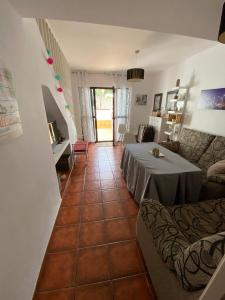 a living room with a table and a couch at Casa Montigar in Chiclana de la Frontera