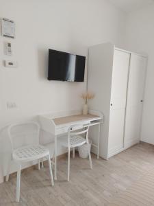 una scrivania bianca con TV a parete di TerraViva B&B a Polignano a Mare
