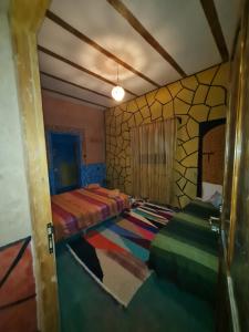Postel nebo postele na pokoji v ubytování Riad Tigmi du Soleil