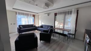 a living room with a couch and a table at The Logo Family Apart in Altınkum