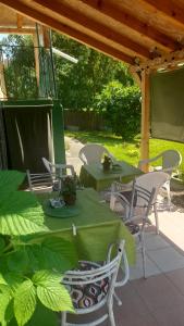 a patio with two tables and chairs under a pergola at Centrala in Vrdnik