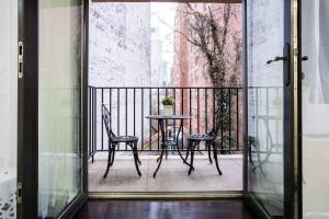 a patio with a table and chairs on a balcony at 809-3B Columbus Circle W D new BLDG Balcony in New York
