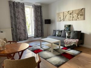 a living room with a couch and a table at Sueños Apartment in Magdeburg