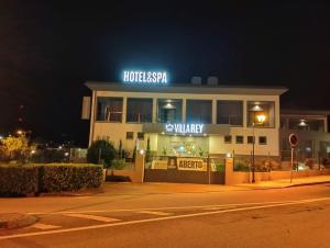 a hotel with a sign on top of it at night at Villa Rey Spa & Hotel in Vila de Rei