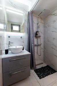a bathroom with a sink and a shower at Plaka Nefeli Elegant Urban Retreat in Athens Historic Heart in Athens
