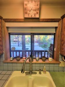 a kitchen sink and a window with a view at Four Seasons Getaway-with Hot Tub, Next to Village and Hiking Trailhead in Big Bear Lake