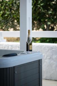 a bottle of wine sitting on top of a table at Anzuelo Apartments in Megalochori