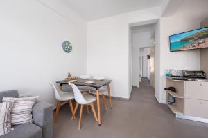 a living room with a dining room table and a couch at Anzuelo Apartments in Megalochori