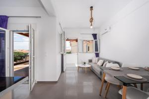 a living room with a couch and a table at Anzuelo Apartments in Megalochori