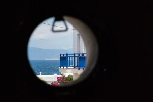 a view of the ocean from a building with a window at Anzuelo Apartments in Megalochori