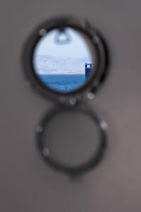 a view of the ocean through a pair of scissors at Anzuelo Apartments in Megalochori