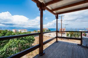 a balcony with a view of the ocean at Anzuelo Apartments in Megalochori