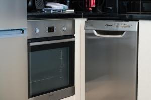 a kitchen with a dishwasher and a stove at Anzuelo Apartments in Megalochori